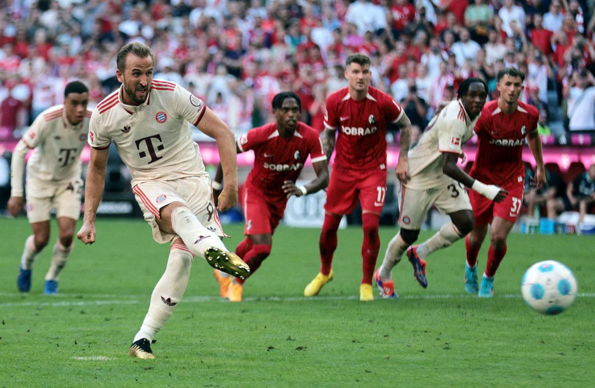 Bayern Munich's Harry Kane scores their first goal from the penalty spot