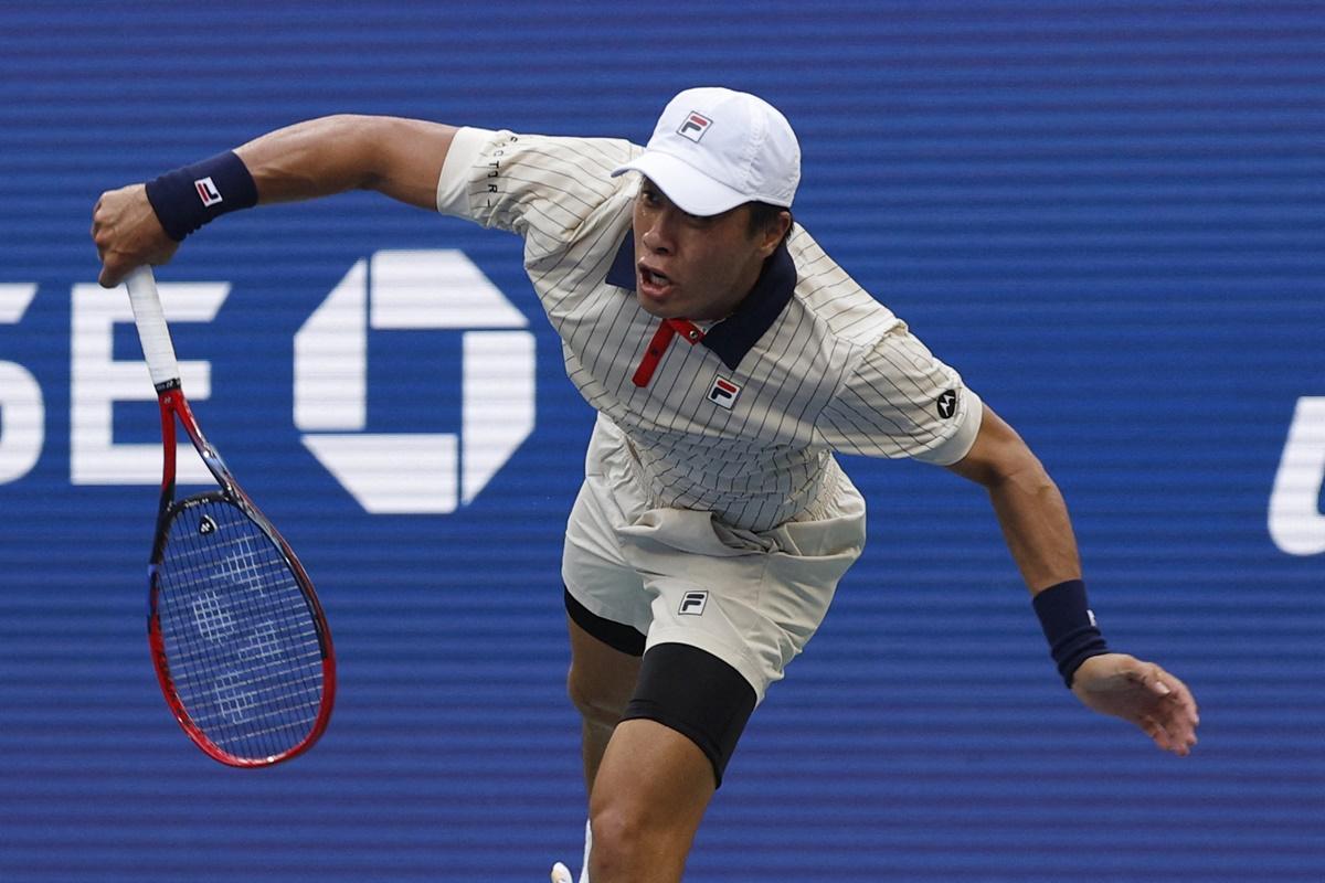 Brandon Nakashima serves against Alexander Zverev.