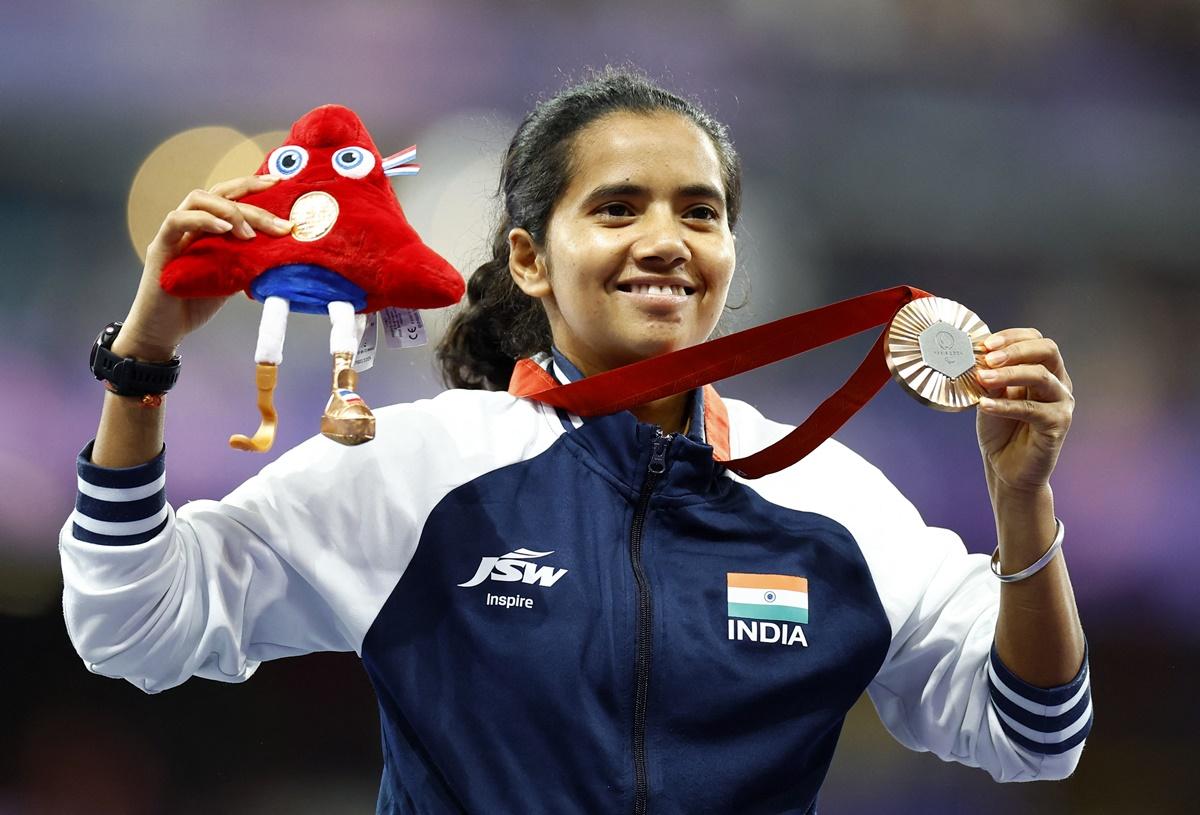 India's bronze medallist Preethi Pal celebrates on the podium after the women's 200 metres T35 medal ceremony at the Paralympics in Paris on Sunday.