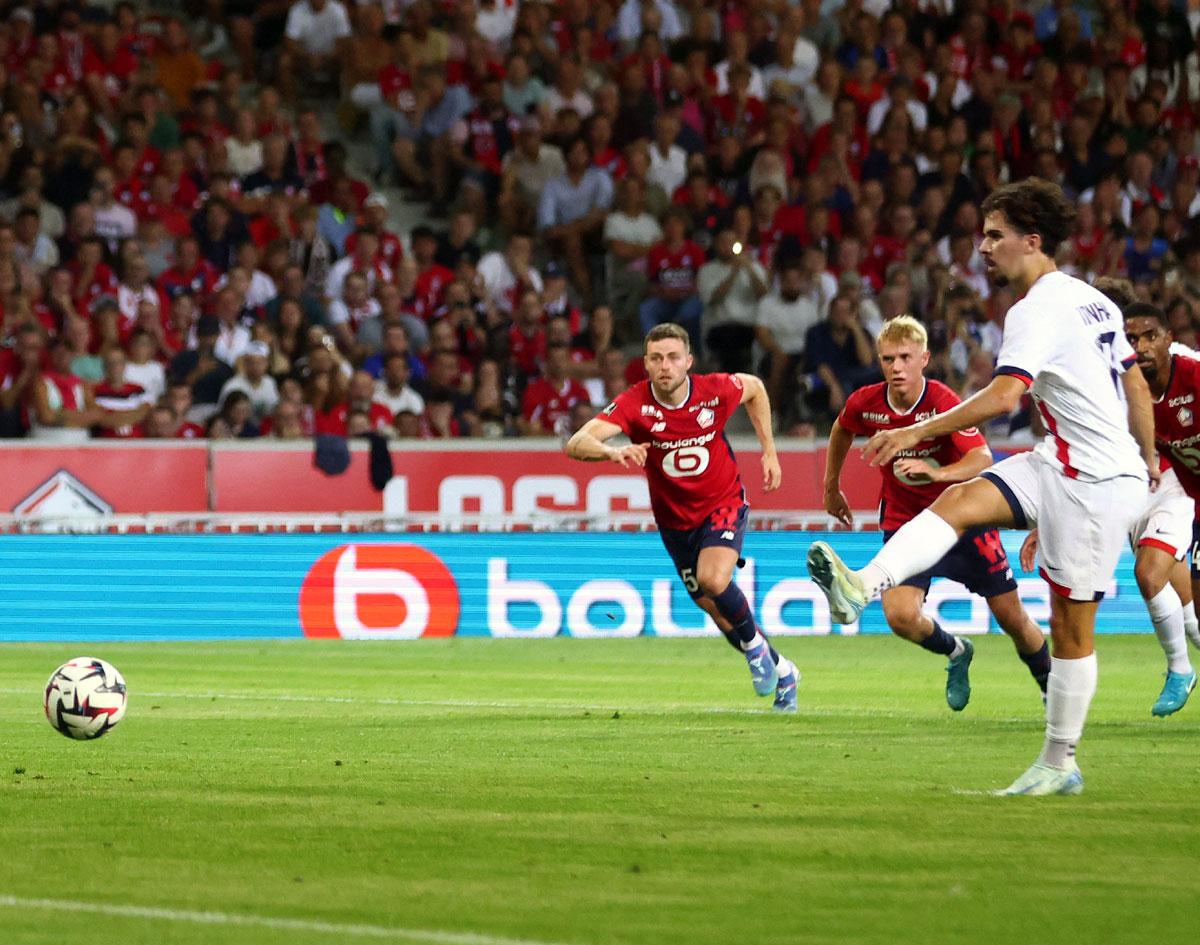 Paris St Germain's Vitinha scores their first goal from the penalty spot