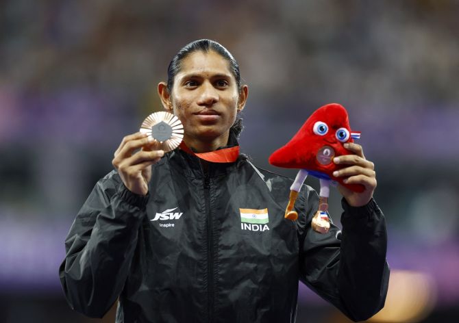 India's Deepthi Jeevanji shows off her bronze medal on the podium after the medal ceremony for the Paralympics women's 400m T20 run at the Stade de France, Saint-Denis, Paris, on Tuesday.