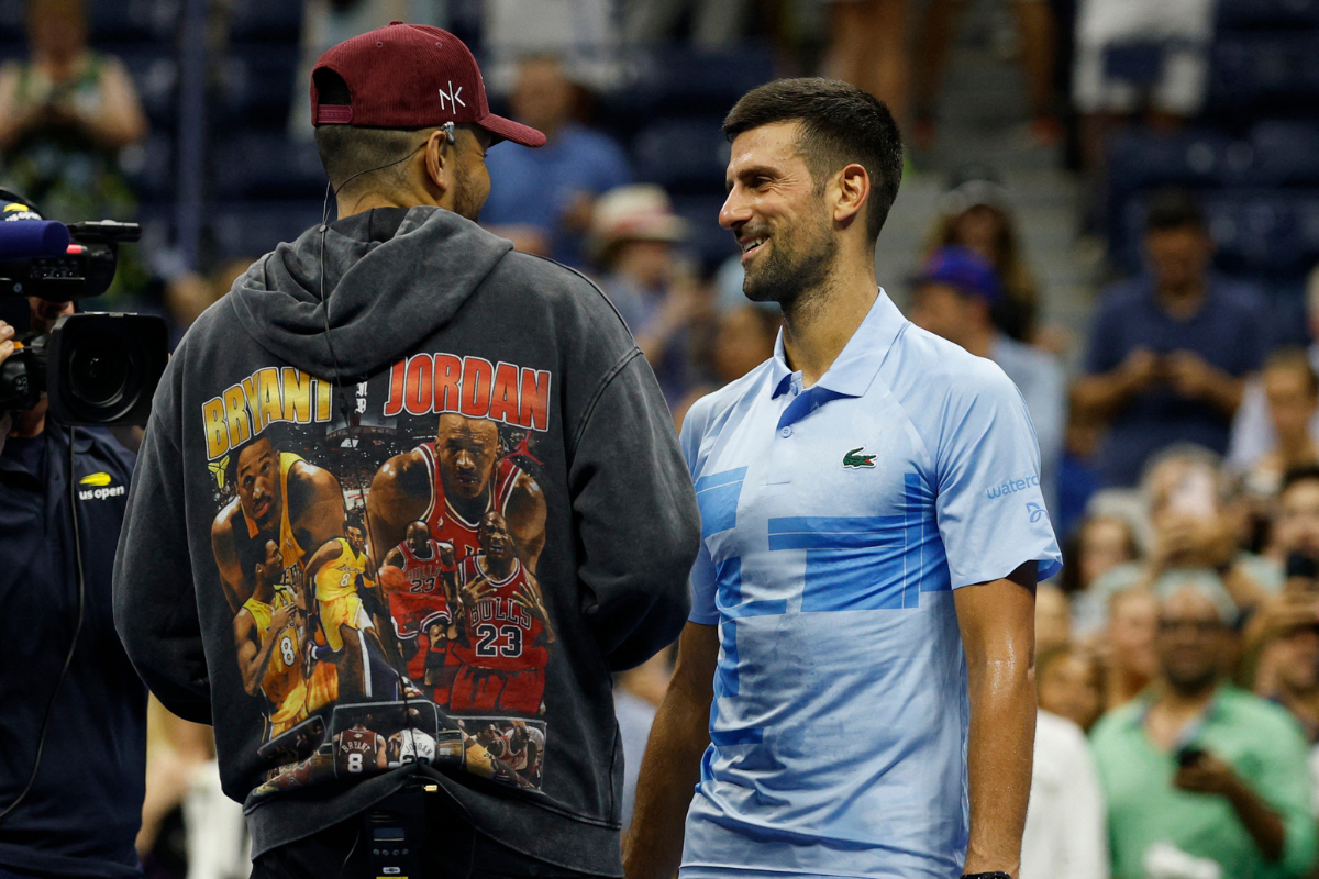 Novak Djokovic (right) talks with on-court interviewer Nick Kyrgios (left) after his match against Laslo Djere (SRB) in a men's singles match on day three of the US Open tennis tournament at USTA Billie Jean King National Tennis Center. 