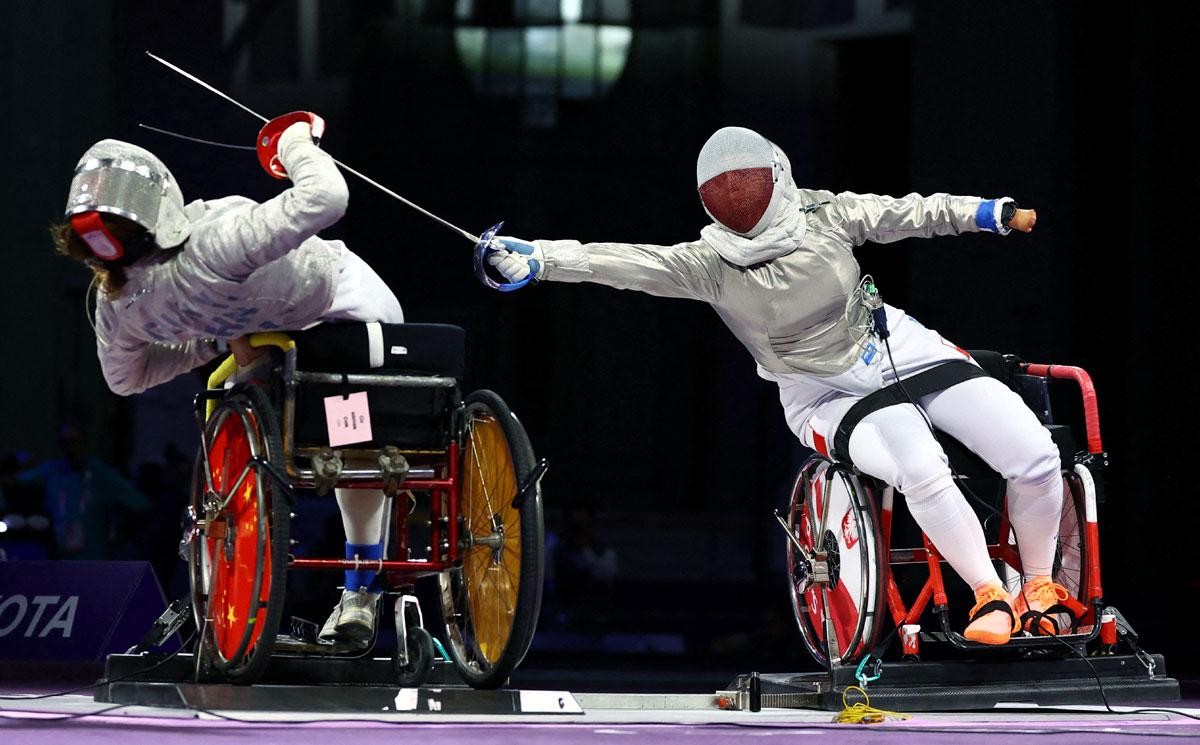 Haiyan Gu of China in action against Kinga Drozdz of Poland during the wheelchair fencing - women's sabre category A gold medal bout