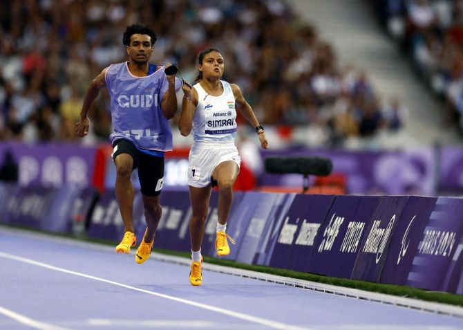 India sprinter Simran, with guide Abhay Singh, runs the Paralympics women's 100 metres Heat 1 at Stade de France, Saint-Denis, Paris, on Wednesday.