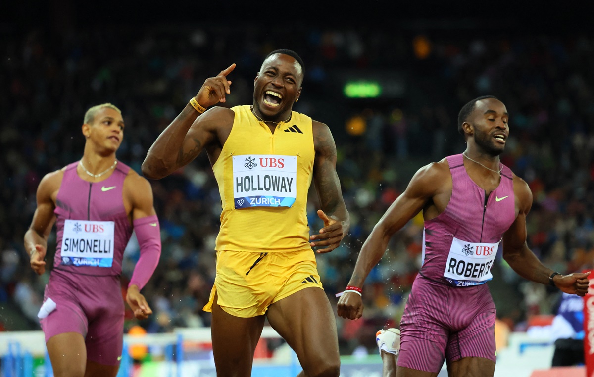 The United States' Grant Holloway breaks into celebration after winning the 110m hurdles