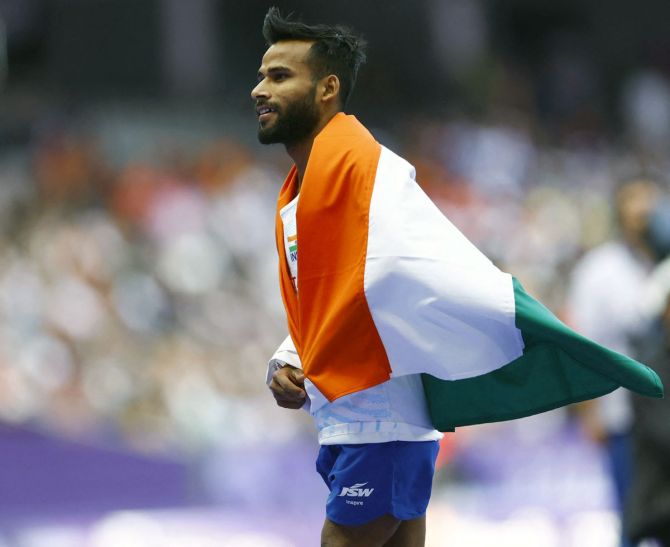 Praveen Kumar celebrates with the tricolour after a record-breaking performance that won him gold the men's High Jump T64 event at the Paralympics in Paris on Friday.