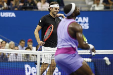 Taylor Fritz smiles after Frances Tiafoe misses an easy return during their US Open semi-final on Friday