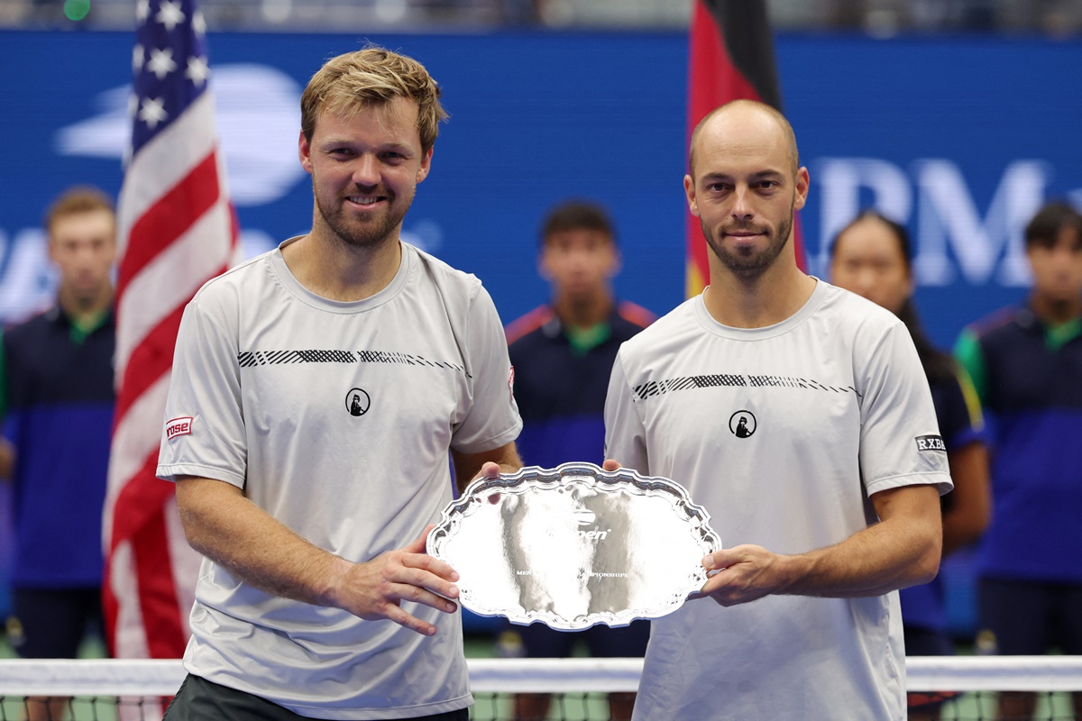 Germany's Kevin Krawietz and Tim Putz pose with the runners-up trophy.