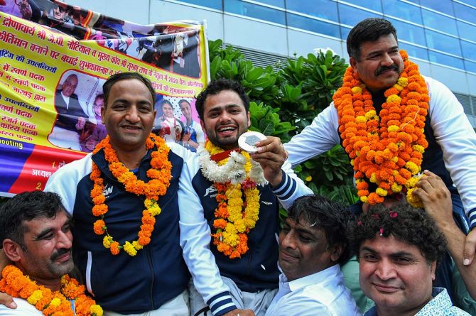  Paris Paralympics Silver Medalist Manish Narwal receives a warm welcome on his return to the country, at IGI Airport in New Delhi on Saturday