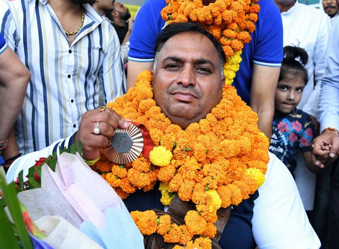 India's para archer Rakesh Kumar poses for a picture with his Bronze Medal