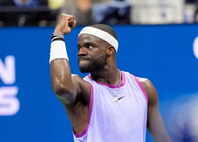 Frances Tiafoe celebrates winning the third set.