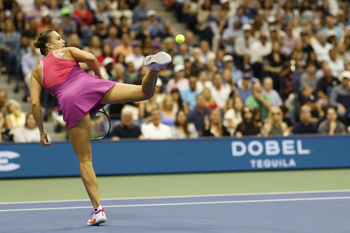 Aryna Sabalenka kicks a ball in frustration after missing a shot against Jessica Pegula