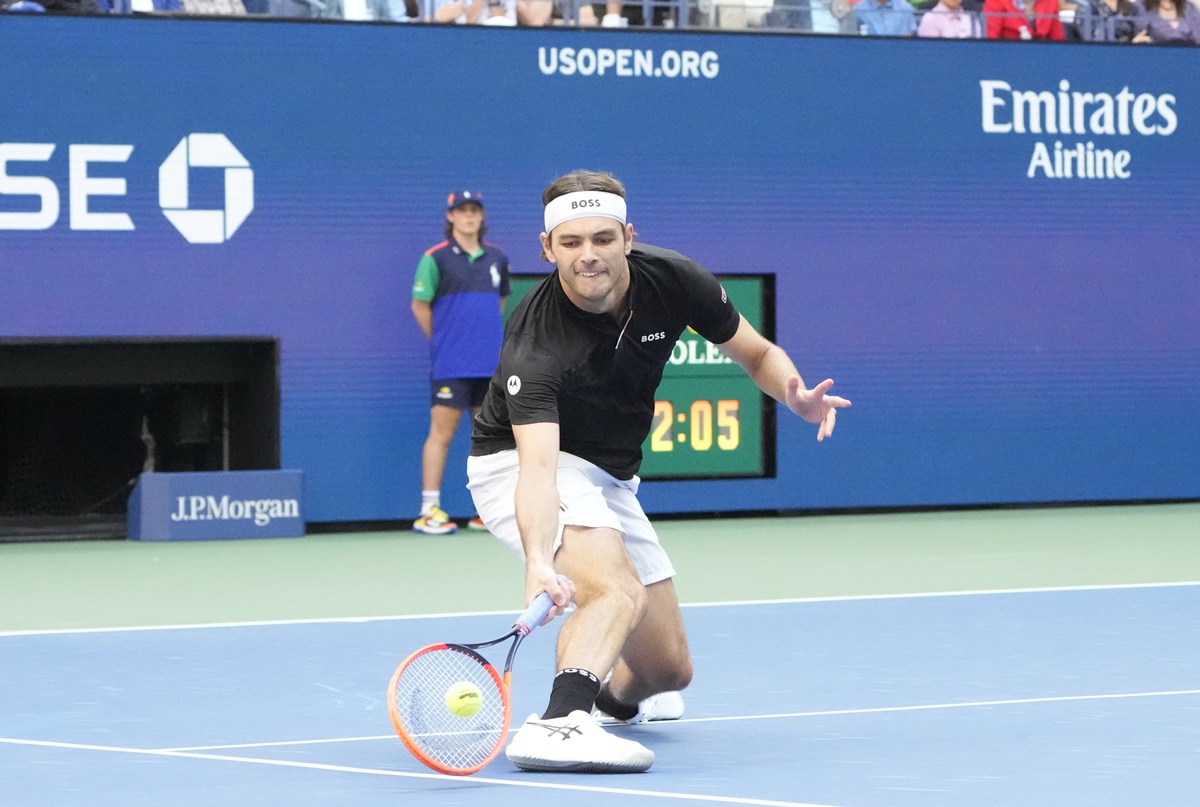 Taylor Fritz rushes to the net to make a drop.