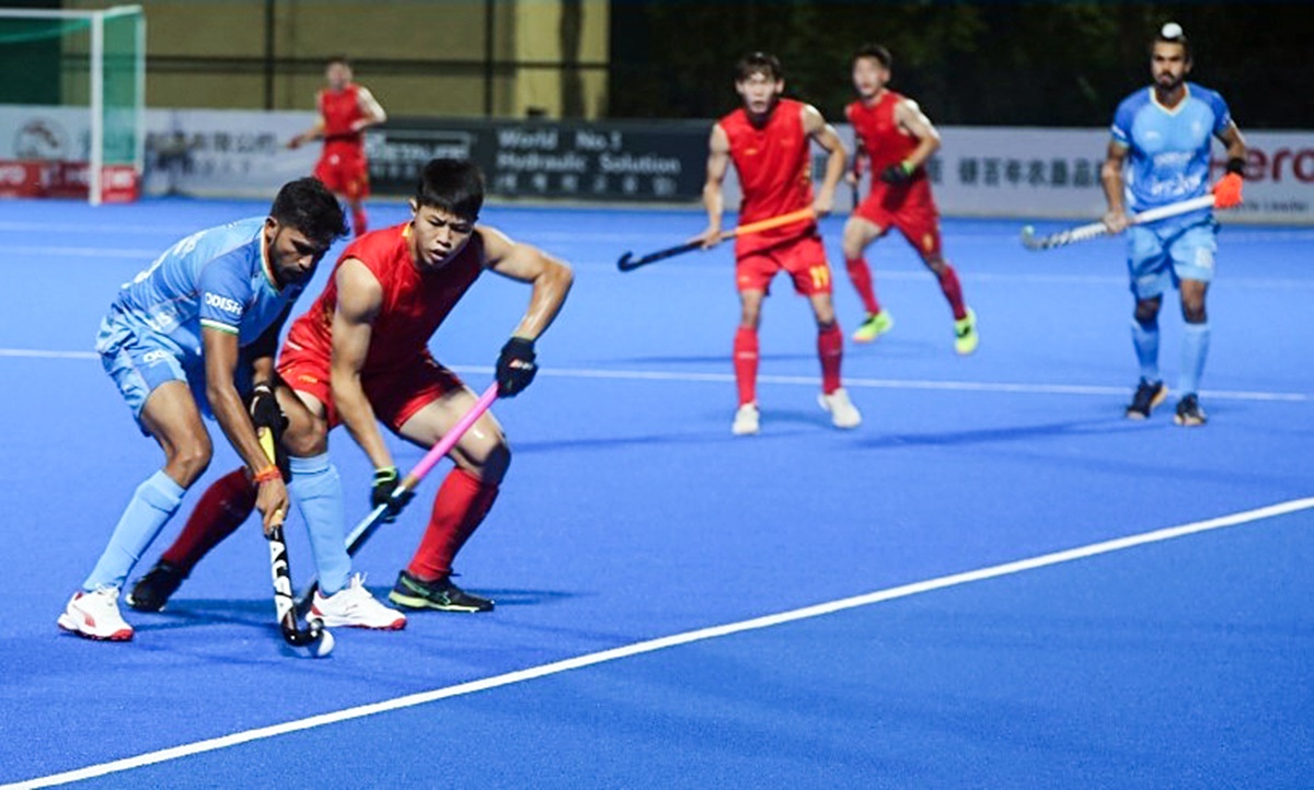 India's Abhishek Nain battles for possession during men's Asian Champions Trophy hockey match against China at Moqi Training Base in Hulunbuir, China, on Sunday.