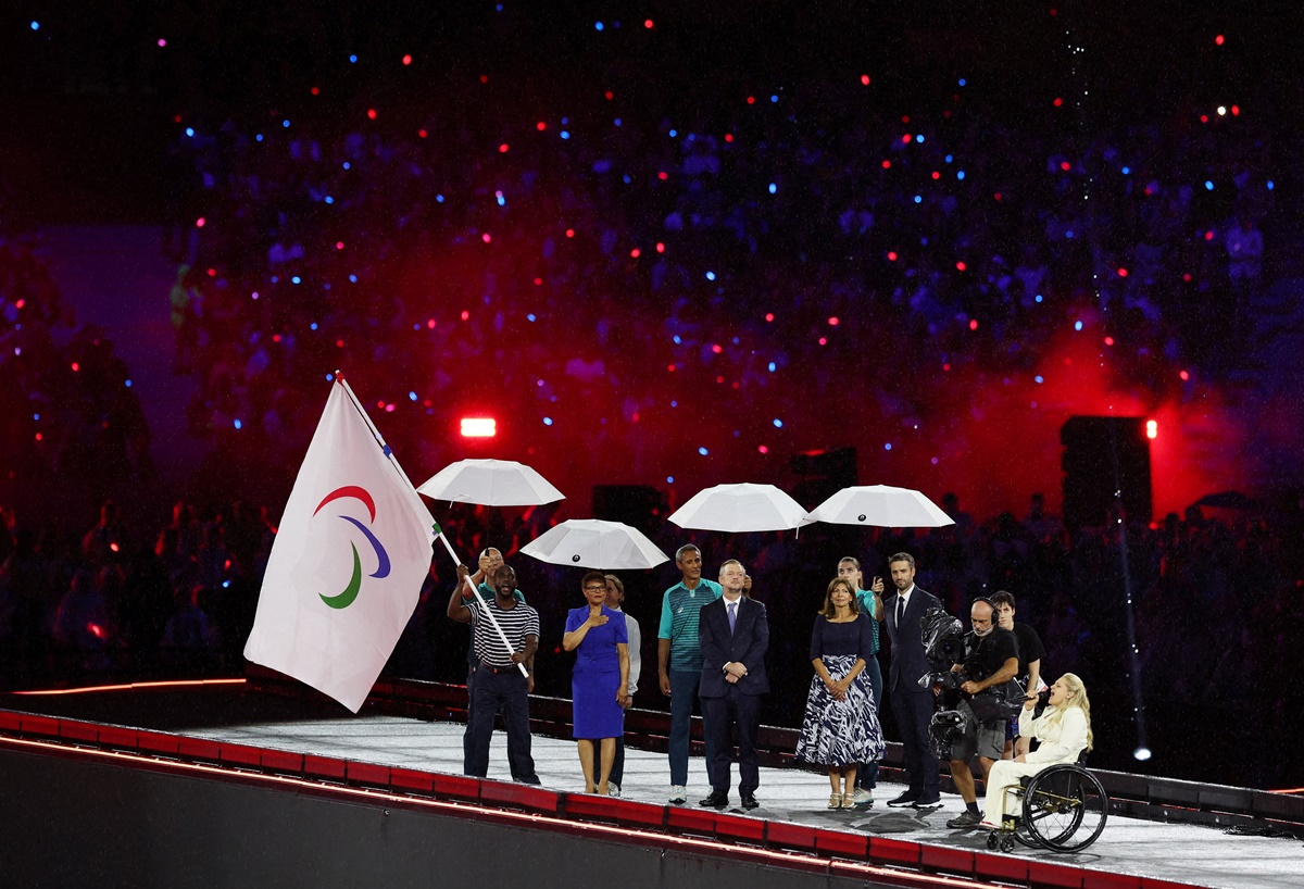 The Paralympic flag is waved amid rain during the closing ceremony in Paris on Sunday.