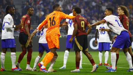 France players Mike Maignan and William Saliba clash with Belgium's Lois Openda