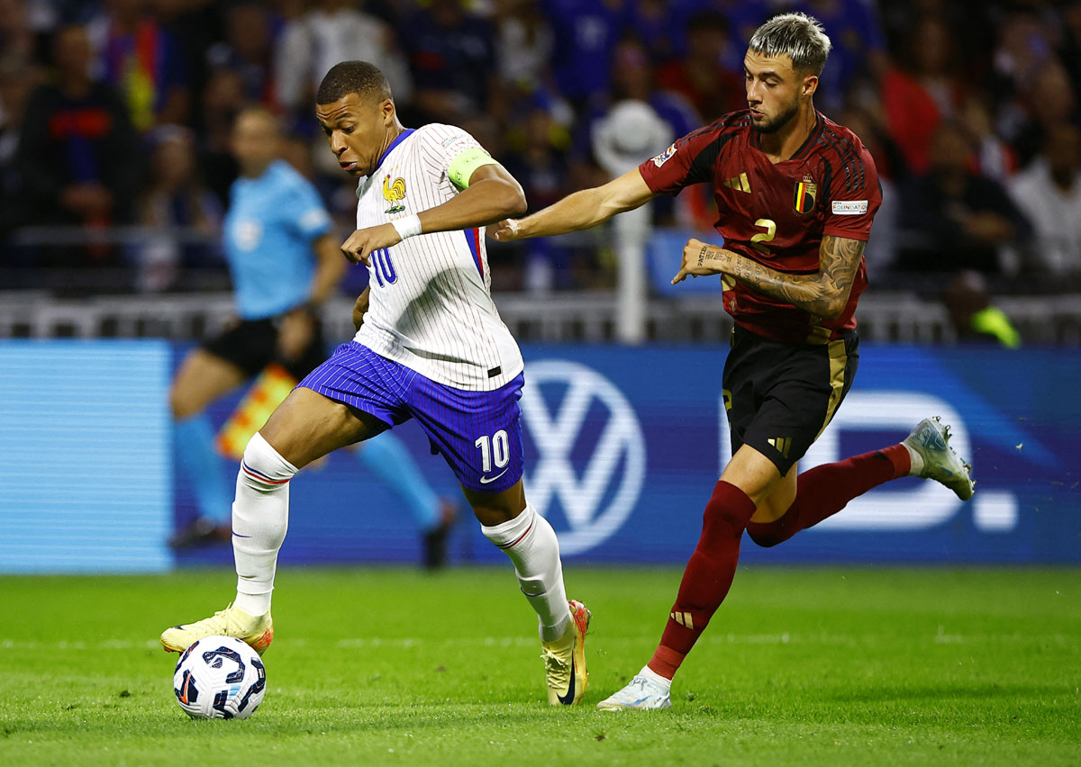 France's Kylian Mbappe tries to get the ball past Zeno Debast of Belgium