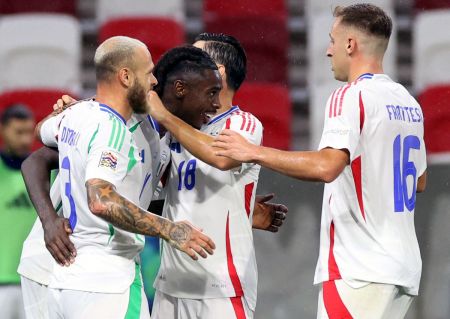 Moise Kean celebrates scoring Italy's second goal with teammates