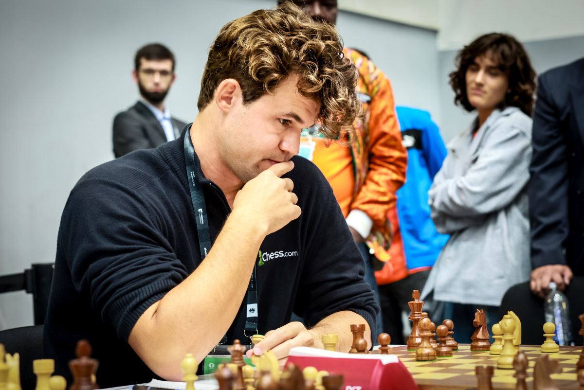 What is Carlsen doing on a bike at Chess Olympiad?