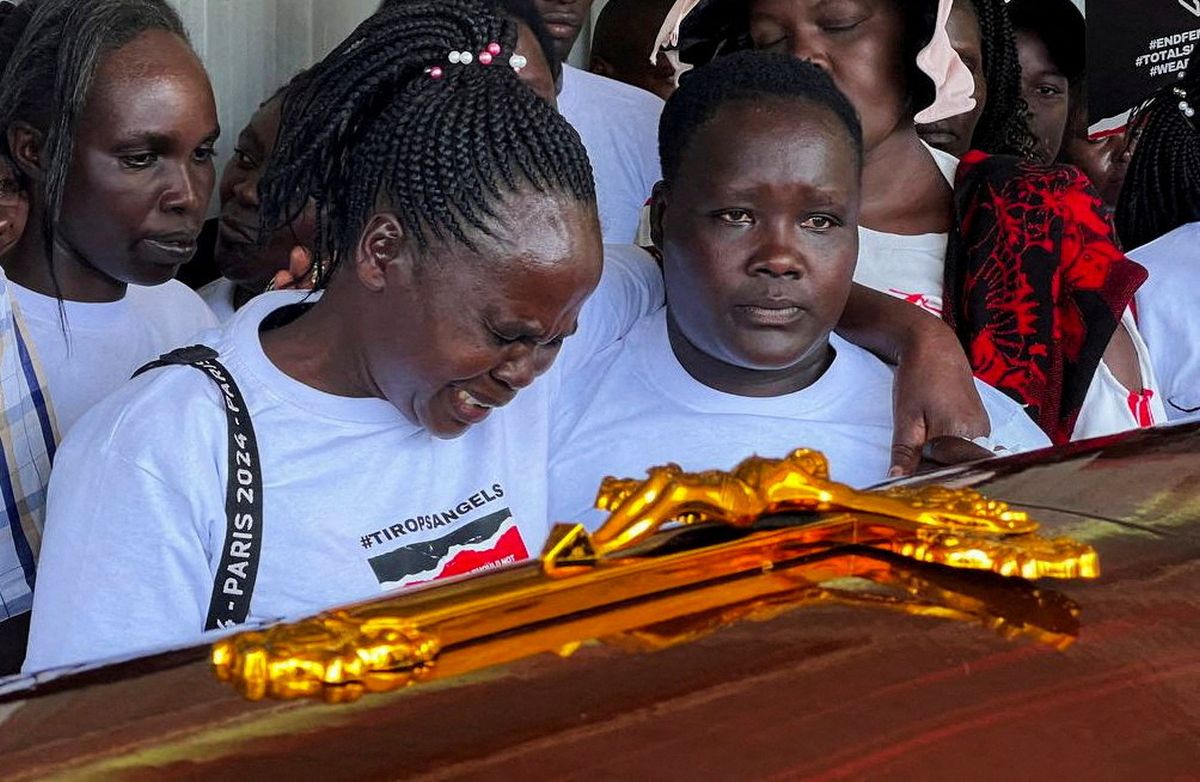 Agnes Cheptegei mourns next to the coffin of her daughter and Olympian Rebecca Cheptegei