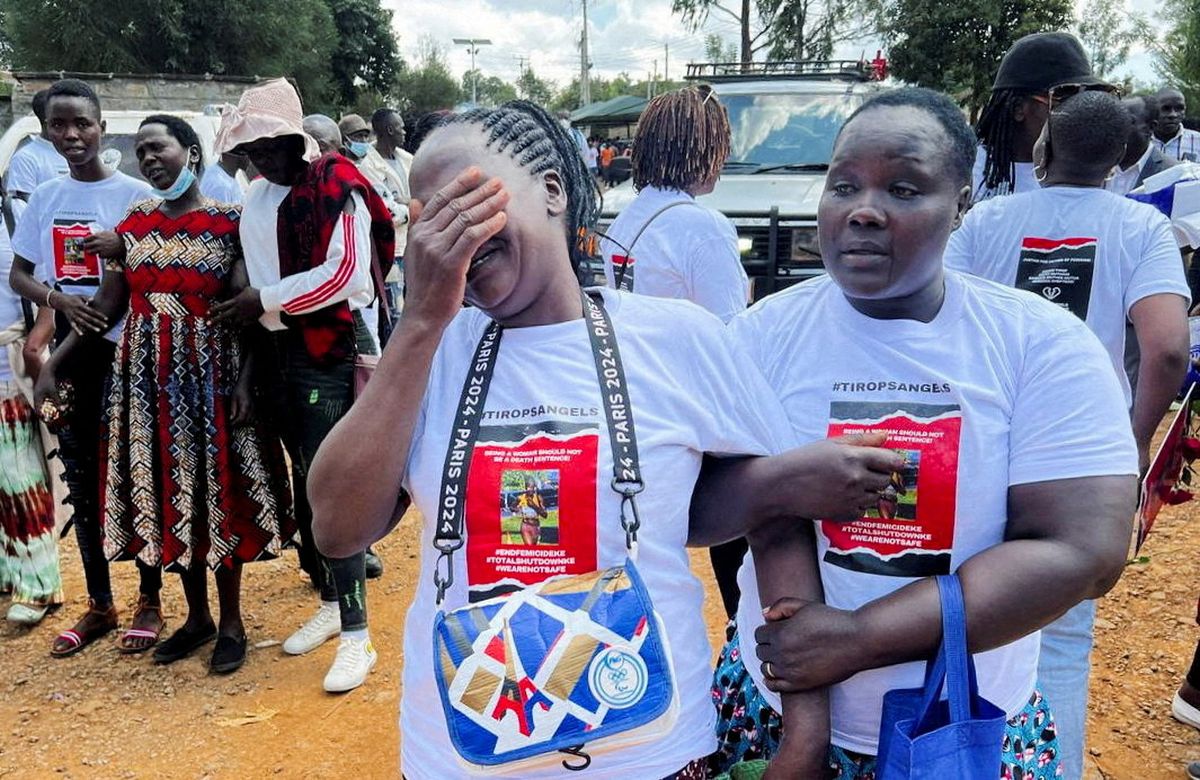 Agnes Cheptegei mourns next to the coffin of her daughter and Olympian Rebecca Cheptegei