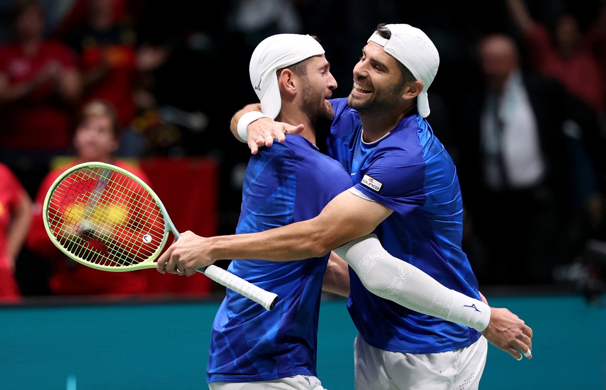 Italy's Simone Bolelli and Andrea Vavassori celebrate winning their doubles match against Belgium's Sander Gille and Joran Vliegen.