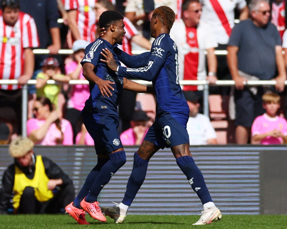 Manchester United's Marcus Rashford celebrates scoring their second goal with Amad Diallo