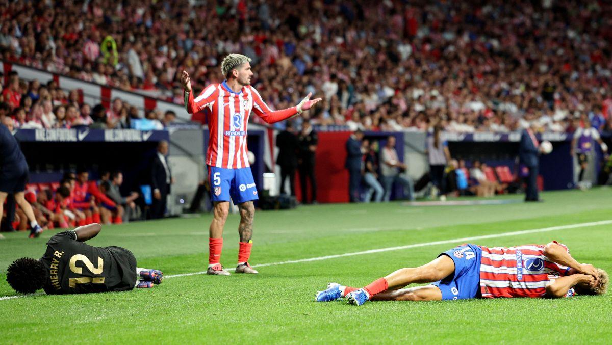 Valencia's Thierry Correia and Atletico Madrid's Marcos Llorente down with injury