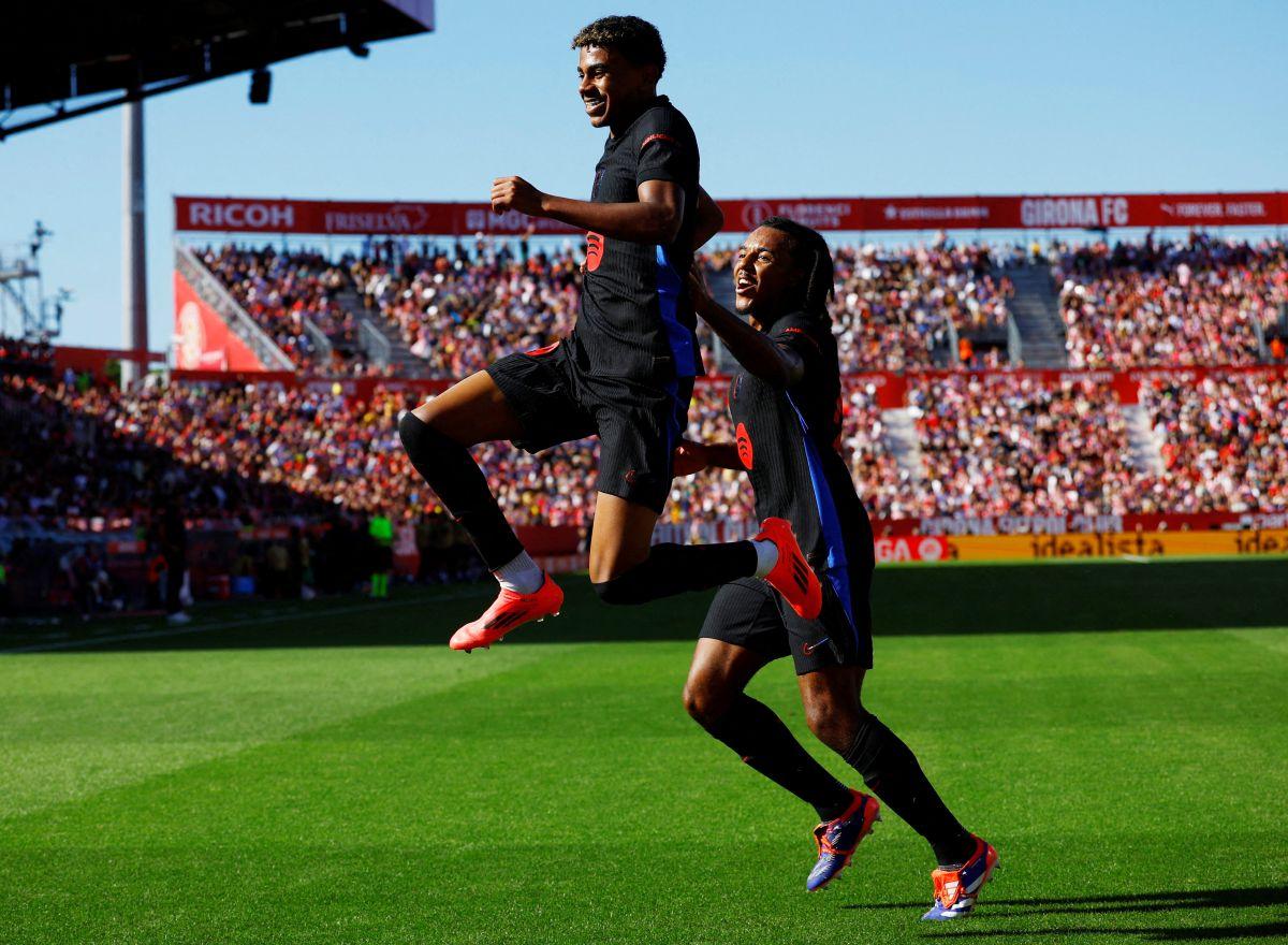 Lamine Yamal, left, celebrates with Jules Kounde after scoring Barcelona's first goal against Girona