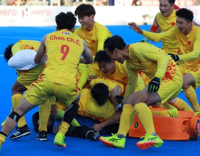 China's players celebrate winning the semi-final against Pakistan