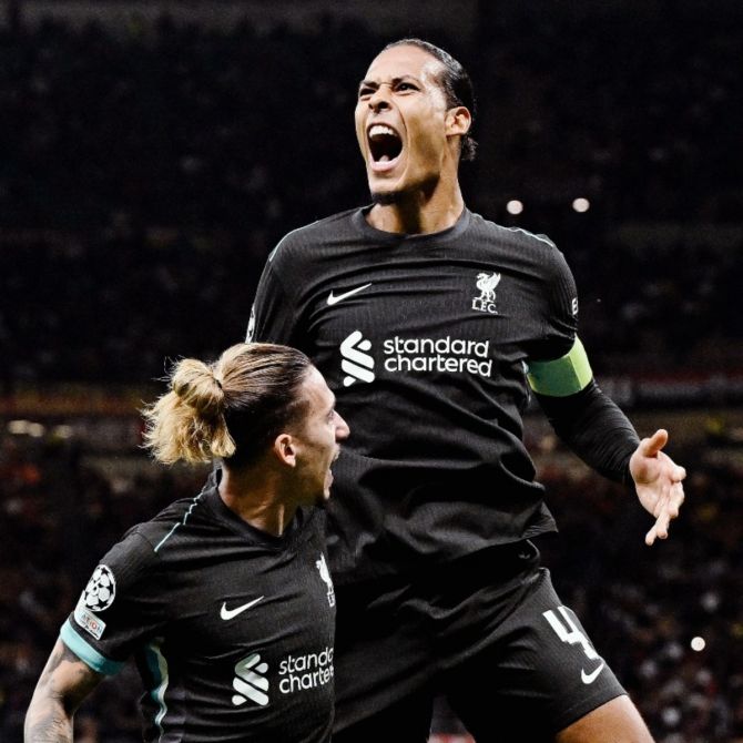 Liverpool's Virgil van Dijk celebrates scoring the second goal against AC Milan 