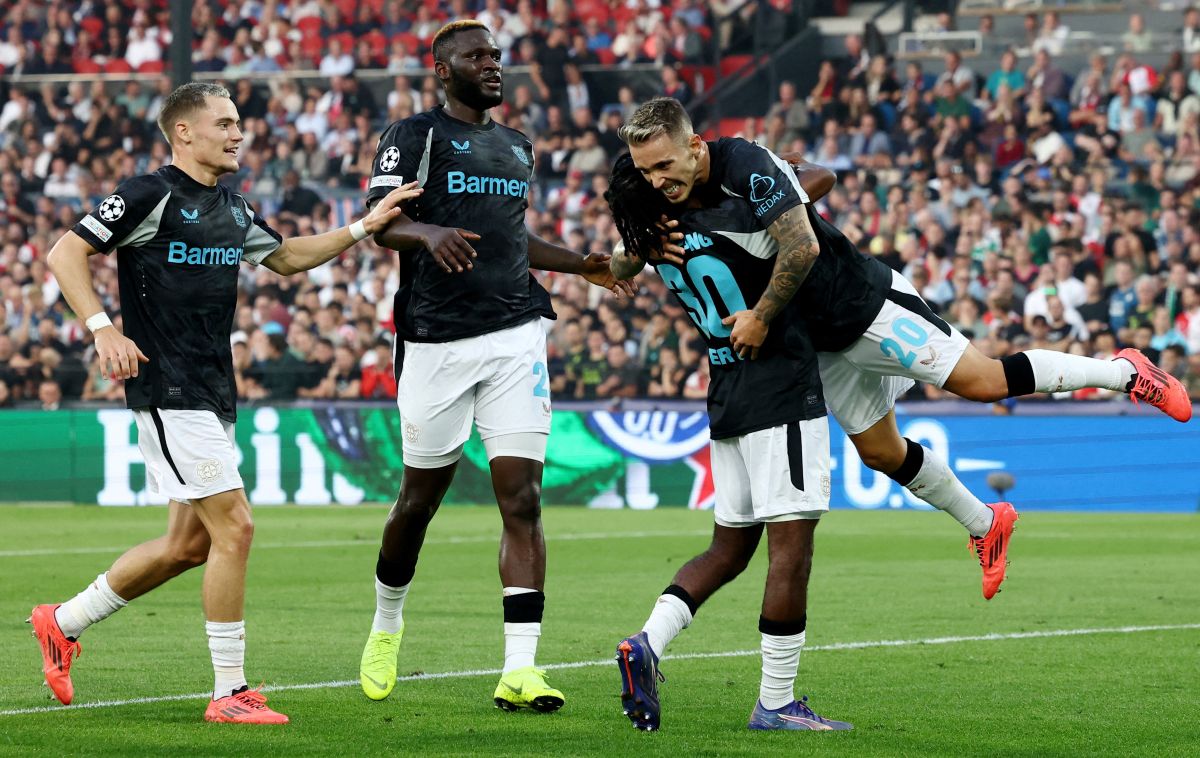 Bayer Leverkusen players celebrate after Alex Grimaldo celebrates scored their second goal