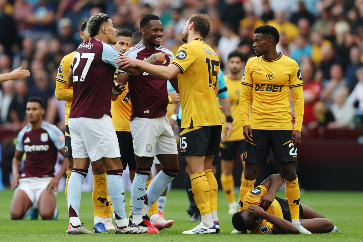 Aston Villa's Morgan Rogers and Jhon Duran clash with Wolverhampton Wanderers' Craig Dawson during their match at Villa Park, Birmingham, Britain