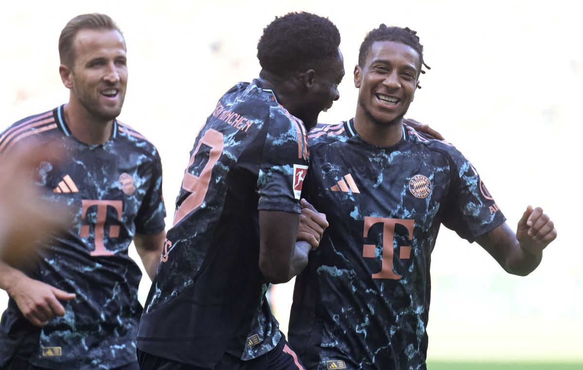 Bayern Munich's Michael Olise celebrates scoring their fourth goal with teammates