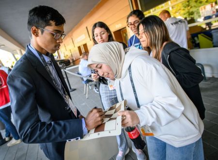 Praggnanandhaa signs autographs for fans outside the venue