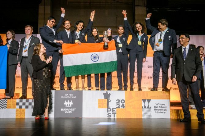 The India women's team celebrate on the podium after winning the gold medal. 