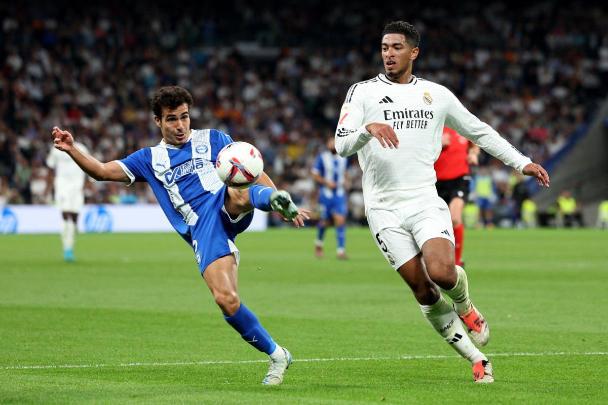 Real Madrid's Jude Bellingham and Deportivo Alaves' Manu Sanchez vie for possession during their La Liga match at Santiago Bernabeu, Madrid, Spain, on Tuesday 