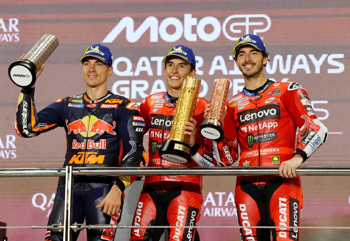 Marc Marquez, Maverick Vinales and Francesco Bagnaia celebrate with their trophies.