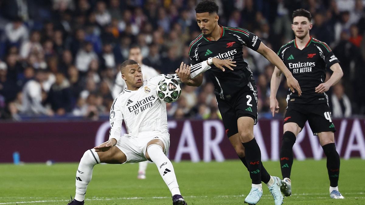 Real Madrid's Kylian Mbappe in fouled by Arsenal's William Saliba as he tries to break through.