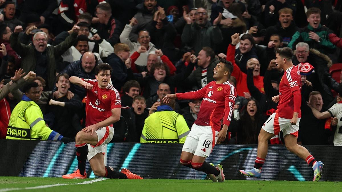 Harry Maguire breaks into celebration along with teammates Casemiro and Harry Amass after scoring the match-winner for Manchester United against Olympique Lyonnais in the Europa League quarter-final second leg at Old Trafford, Manchester, on Thursday.