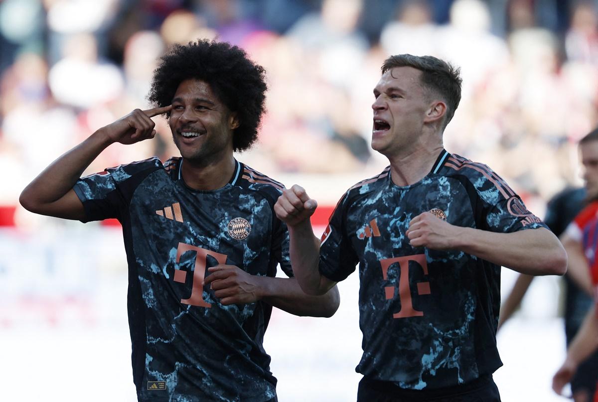 Joshua Kimmich celebrates scoring Bayern Munich's fourth goal with Serge Gnabry during the Bundesliga match against FC Heidenheim at Voith-Arena, Heidenheim, Germany.