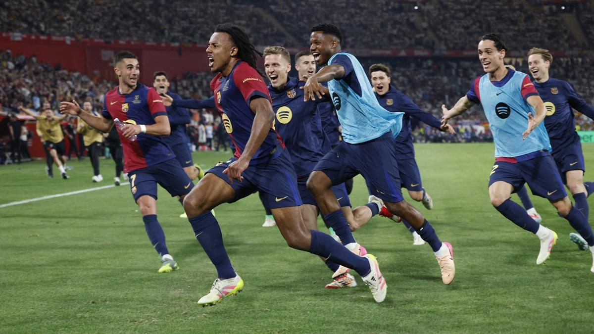 Barcelona's players break into celebration with Jules Kounde after he scores in extra-time of the Copa del Rey final against Real Madrid at Estadio de La Cartuja, Seville, Spain, on Saturday.