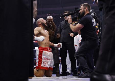 Chris Eubank Jr celebrates with his father, former boxer Chris Eubank, after defeating Conor Benn.