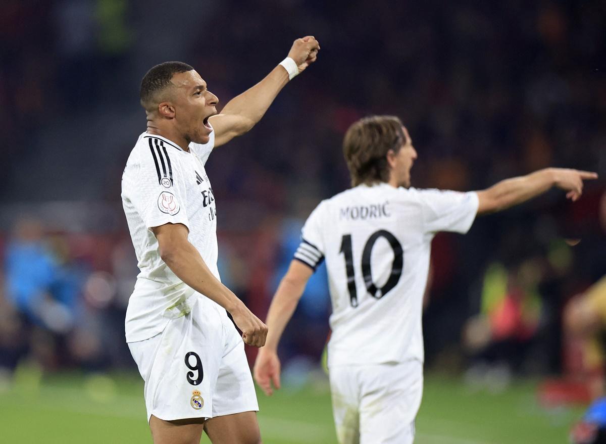 Kylian Mbappe celebrates with Luka Modric after scoring Real Madrid's first goal.