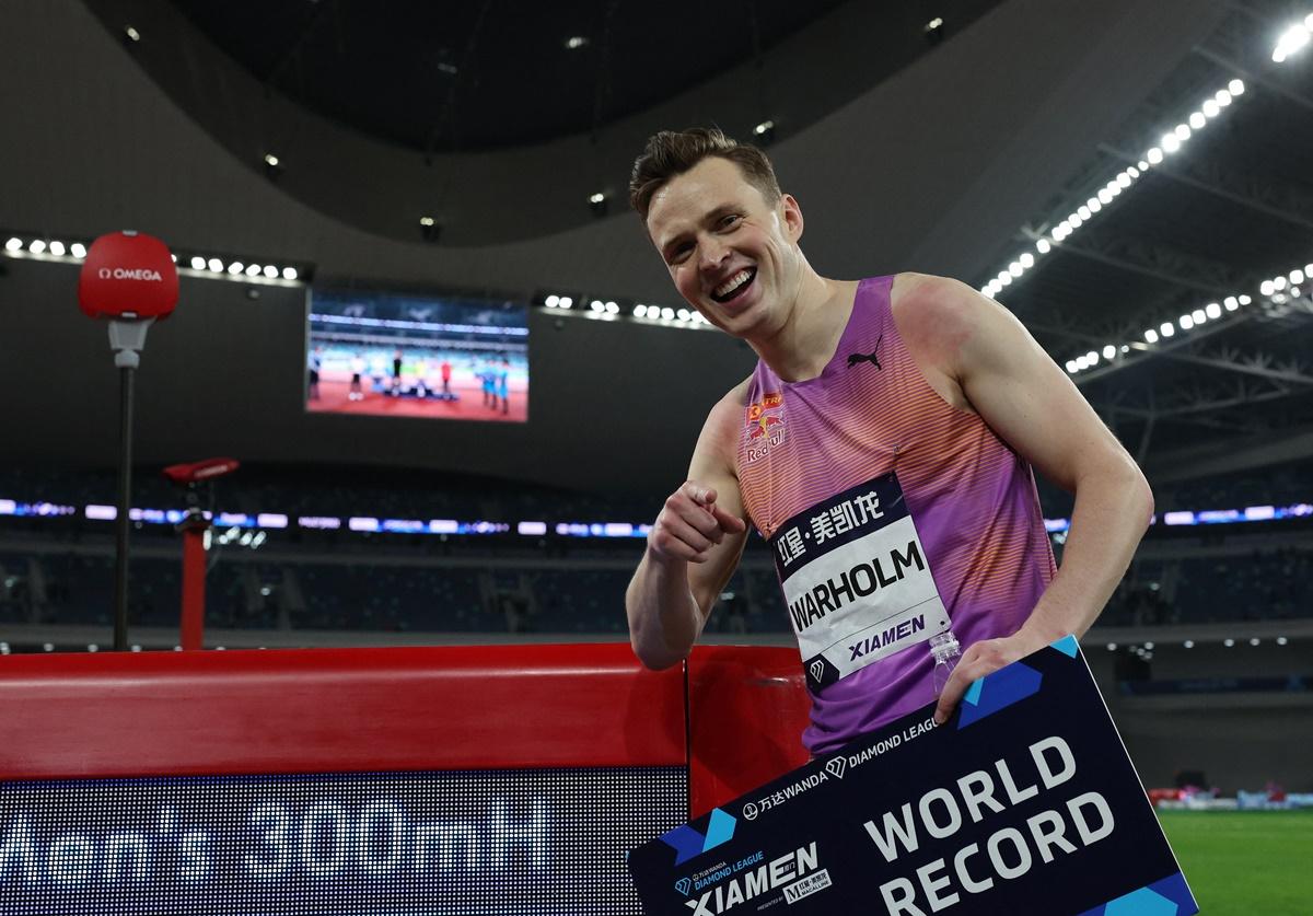 Karsten Warholm celebrates after setting a new World record in the men's 300m hurdles.