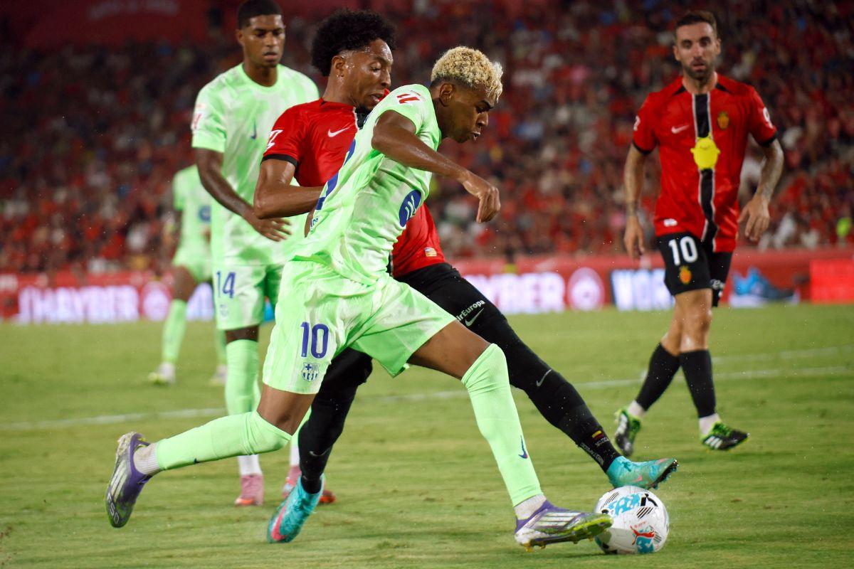 FC Barcelona's Lamine Yamal in action with RCD Mallorca's Johan Mojica during their LaLiga match at Estadi Mallorca Son Moix, Palma de Mallorca, Spain, on Saturday
