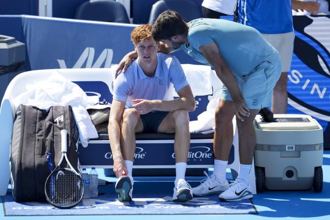 Jannik Sinner chats with Carlos Alcaraz after pulling out from the final after 23 minutes of play, raising concern about his fitness just days before he is due to begin the defence of his US Open title.