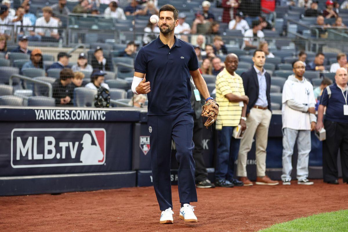 Novak Djokovic prepares to throw out the first pitch prior to the game between the Boston Red Sox and the New York Yankees at Yankee Stadium