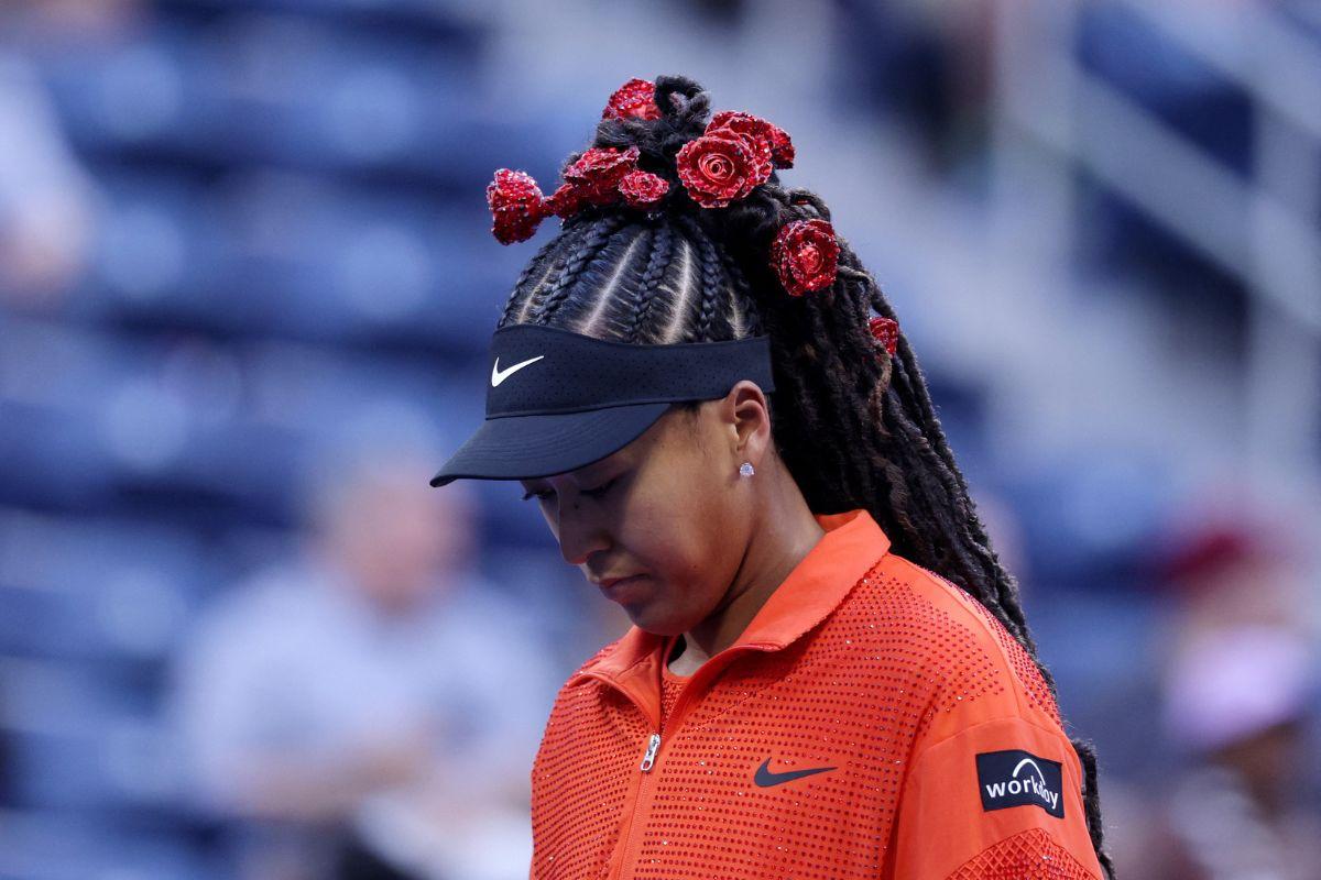 Japan's Naomi Osaka walks out to play her US Open first round match against Belgium's Greet Minnen in an eye-catching hairdo, on Tuesday