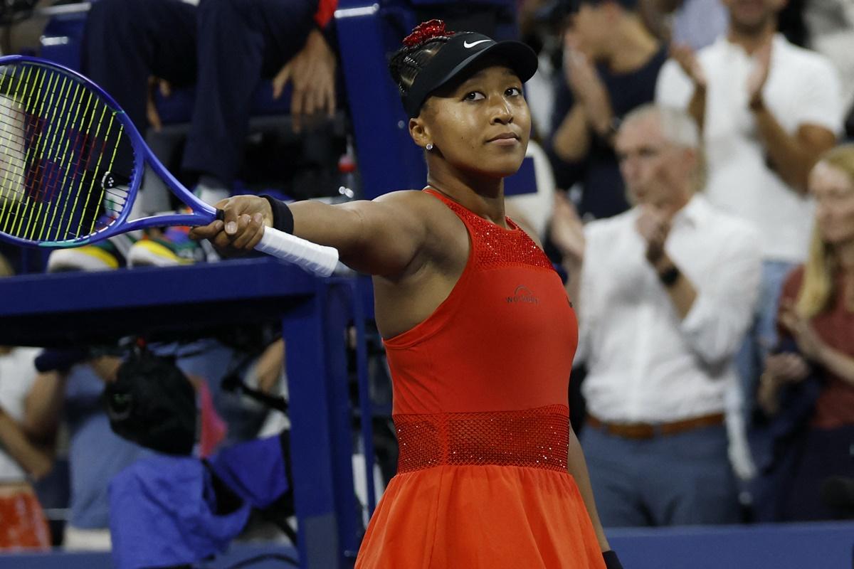 Japan's Naomi Osaka celebrates victory over Belgium's Greet Minnen.